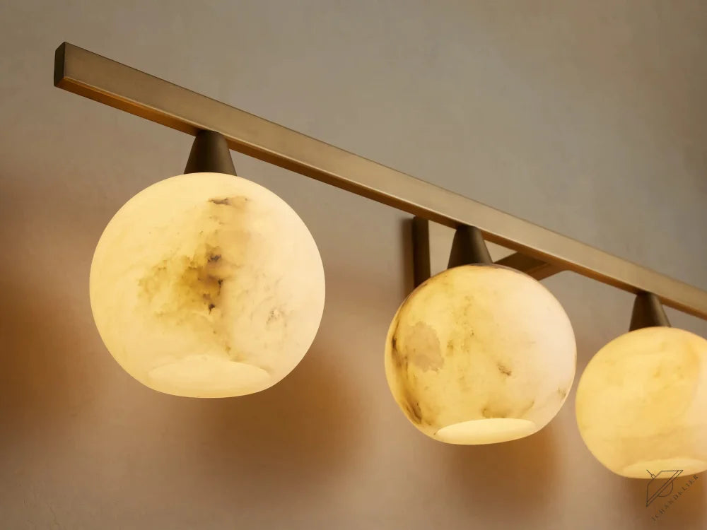 ichandelier Arica 4-light sconce with alabaster globes and a brushed brass finish.