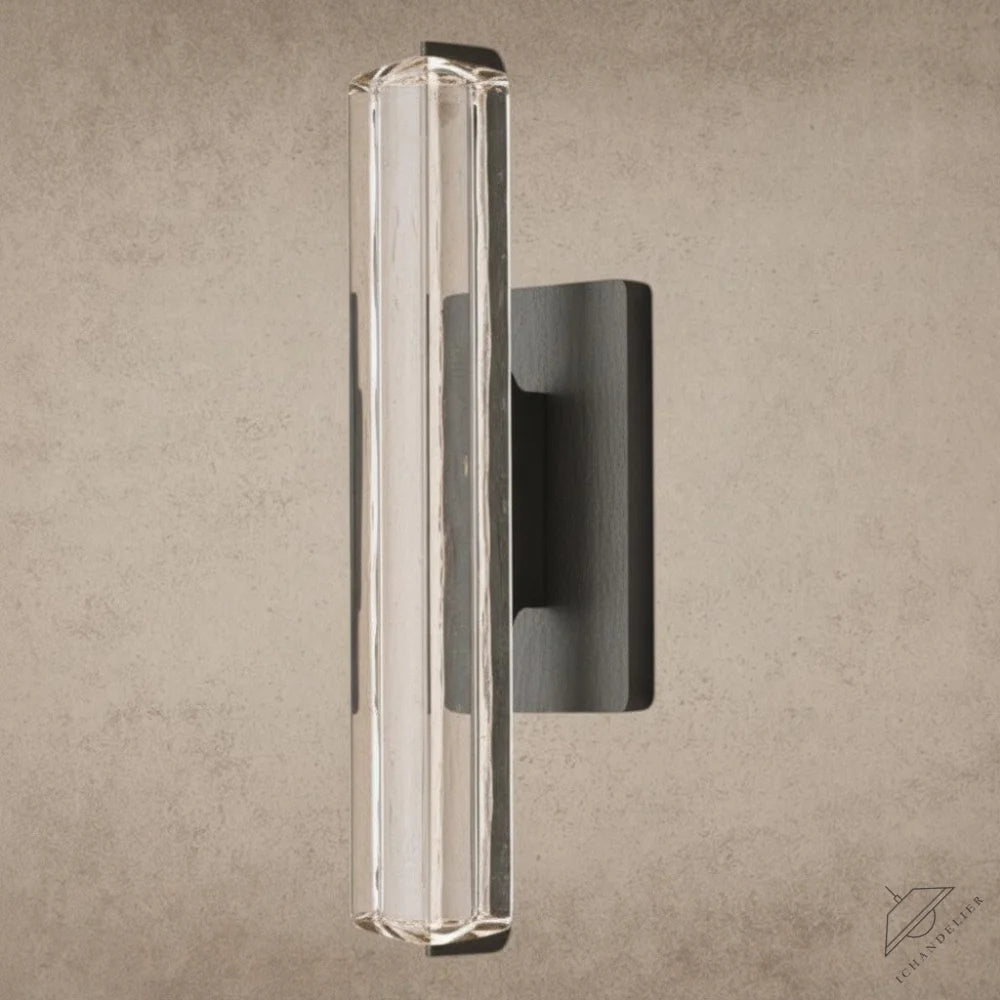 ichandelier Audubon Crystal Single Sconce, clear glass cylinder with faceted details, mounted on dark metal base.