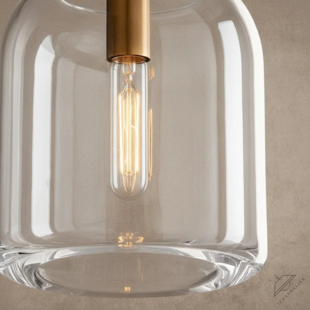 ichandelier Botanist Cloche Pendant, clear glass shade with brass accents and exposed Edison bulb