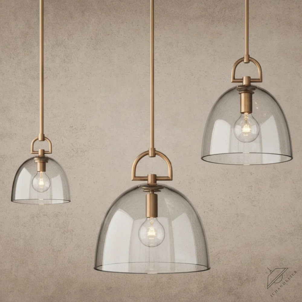 ichandelier Botanist-Dome-Pendant, clear glass dome pendant light with brass hardware and visible bulb.