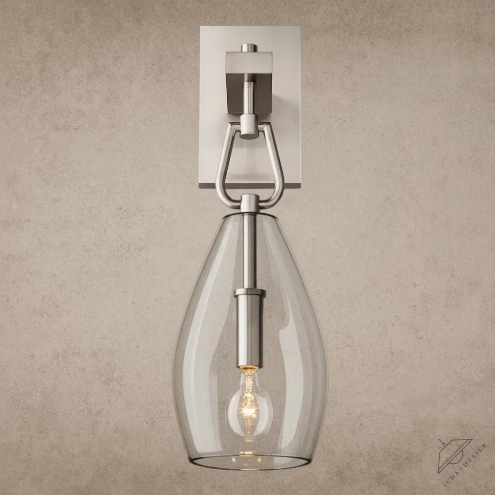 ichandelier Botanist Flute Sconce, modern brushed nickel wall light with clear glass shade and exposed bulb.