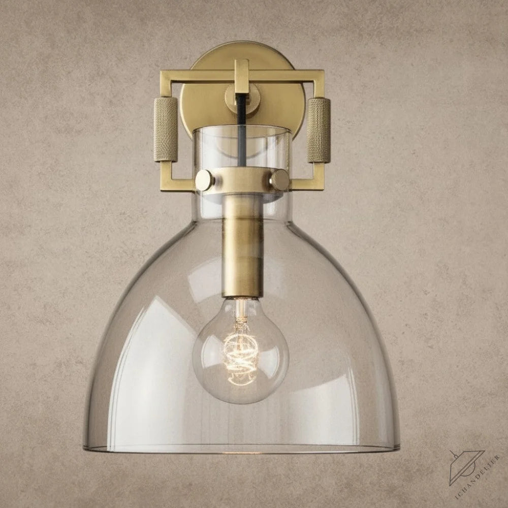 ichandelier Machinist Glass Cloche Sconce, a brass wall light with a clear glass shade and exposed bulb.